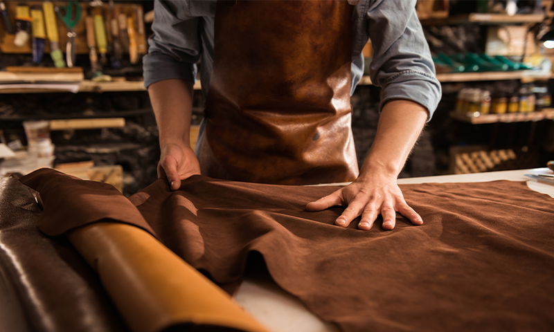 close-up-cobbler-working-with-leather-textile