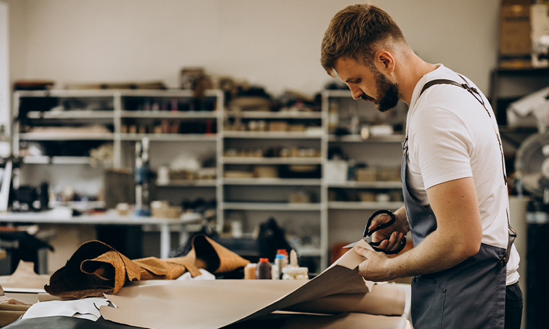 man-tailor-working-with-leather-fabric